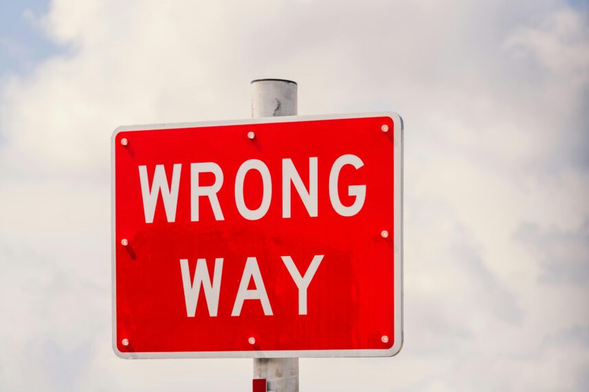 A red sign saying 'Wrong Way'